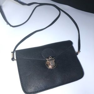Black crossover with gold clasp